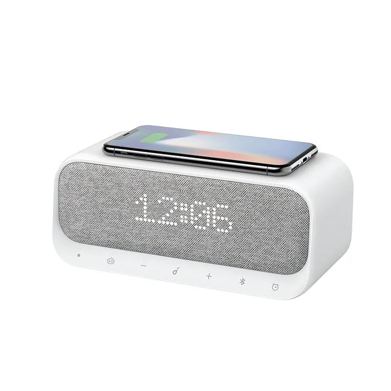 White Anker Soundcore Bluetooth speaker with wireless charging top, LED display, and touch controls.
