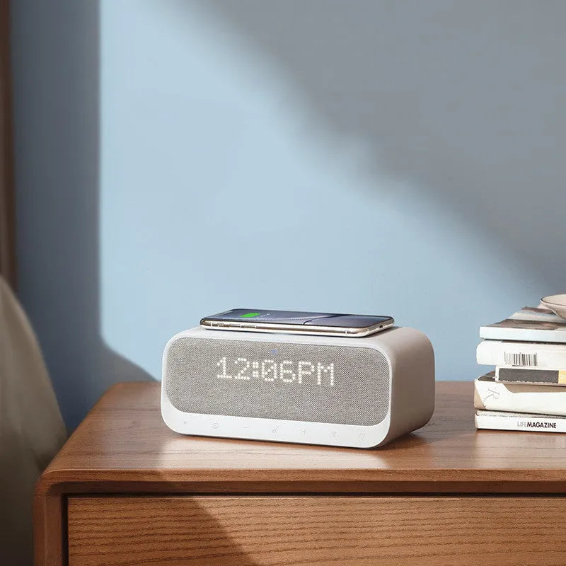 White Anker Soundcore Bluetooth speaker with wireless charging top, LED display, and touch controls.
