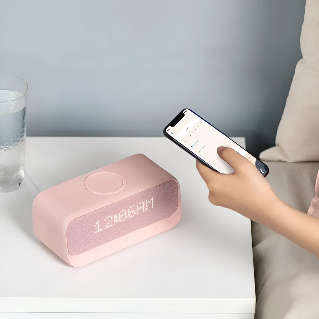 White Anker Soundcore Bluetooth speaker with wireless charging top, LED display, and touch controls.
