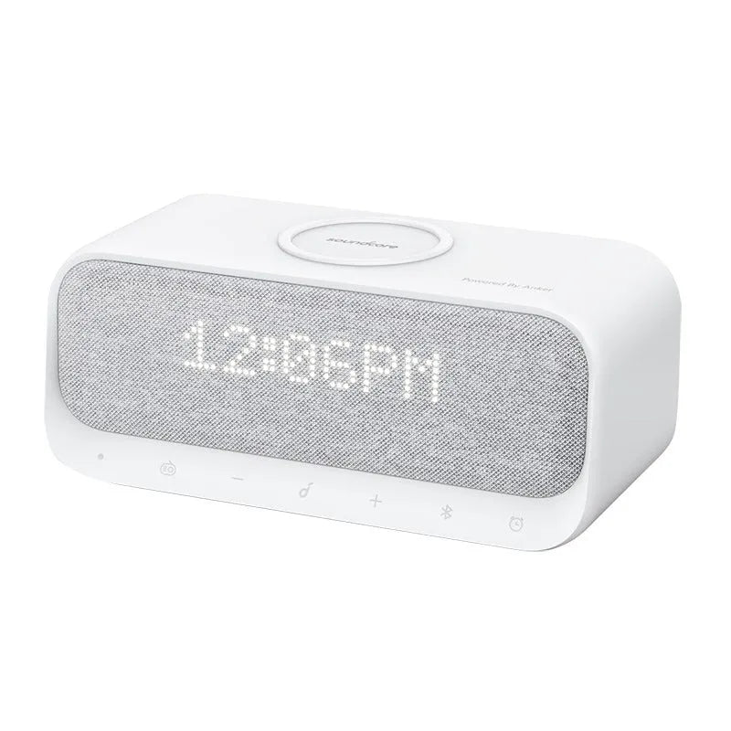 White Anker Soundcore Bluetooth speaker with wireless charging top, LED display, and touch controls.