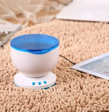 Blue coloured ocean wave light projector with DLP technology on a surface.