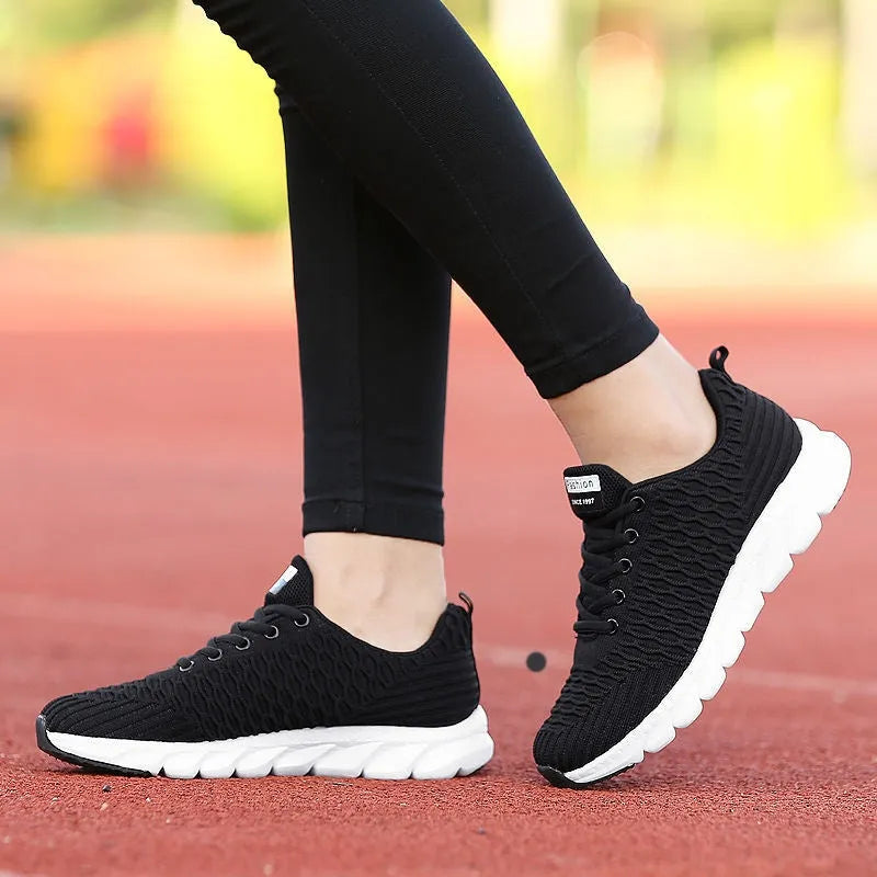Women's running shoes in black, pink, or white with fly weaving upper and wear-resistant outsole