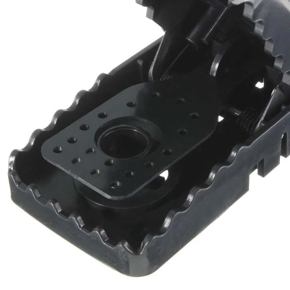 Six black plastic snapping mousetraps showing trigger mechanism and spring design