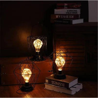 Minimalist hollow wrought iron table lamp in red wine glass style with warm white LED light.