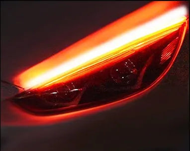 Car LED daytime running light strip with flowing turn signal indicator in silicone housing