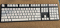 PBT thermal sublimation keycap set showing Japanese Russian Korean multilingual layouts with colour options