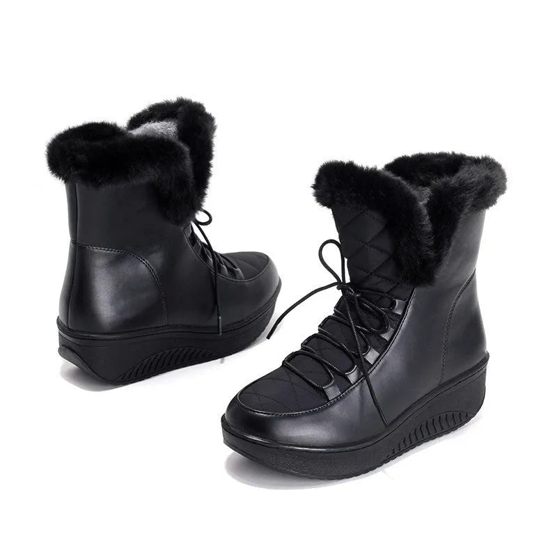 Women's black lace-up winter boots with a platform sole on a neutral background.