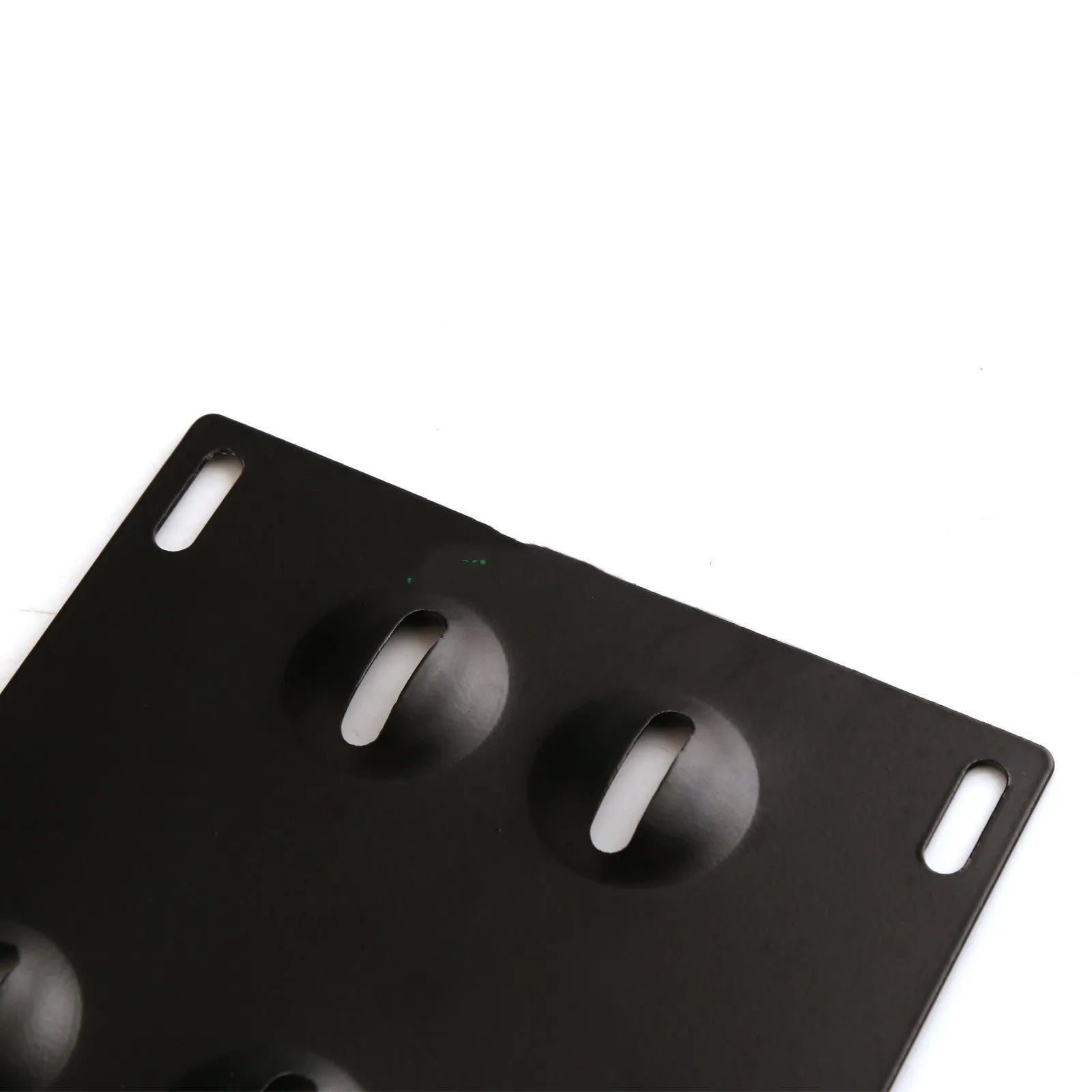 Silver metal car licence plate frame with a central towing hook, next to screws and a nut.