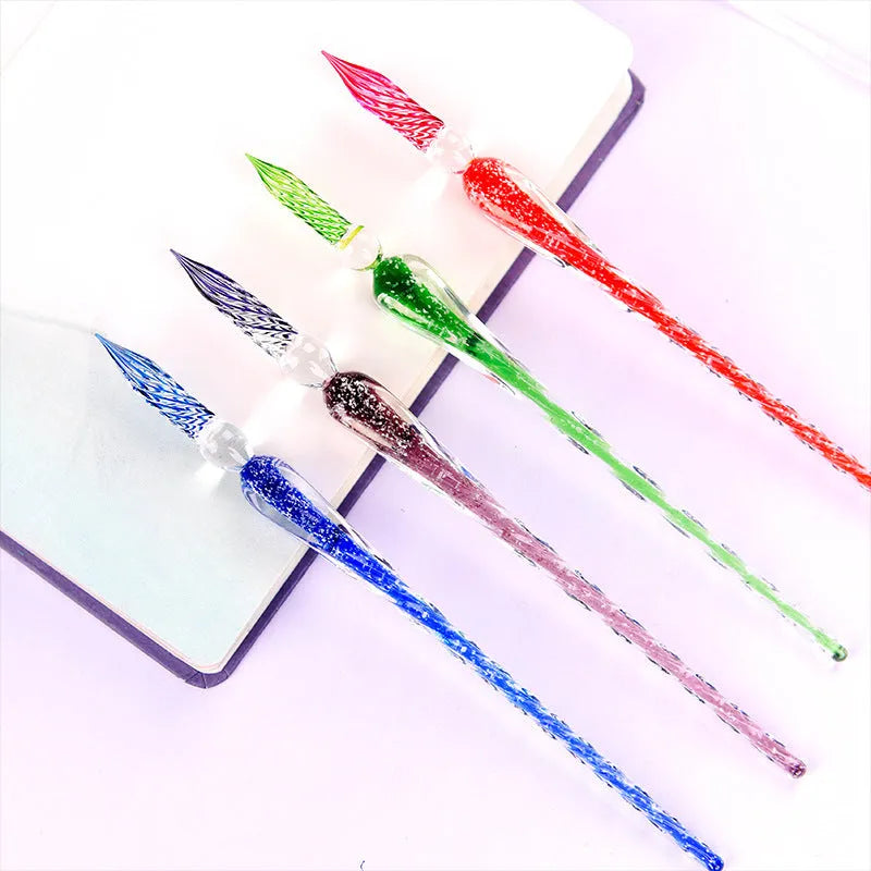 Crystal glass dip pen with transparent body and coloured ink, on a white background