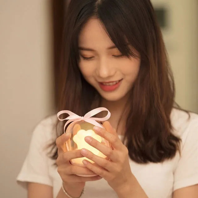 Cat paw-shaped night light with music box function showing pink colour option with illuminated soft light