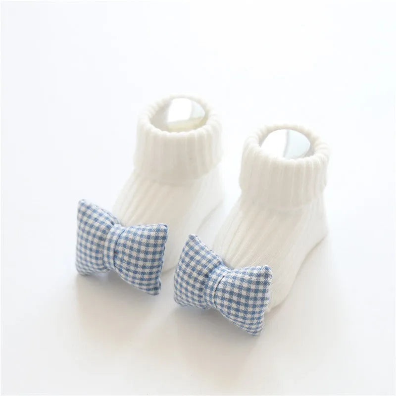 Cotton baby floor socks in blue bow pattern for infants 0-3 months.