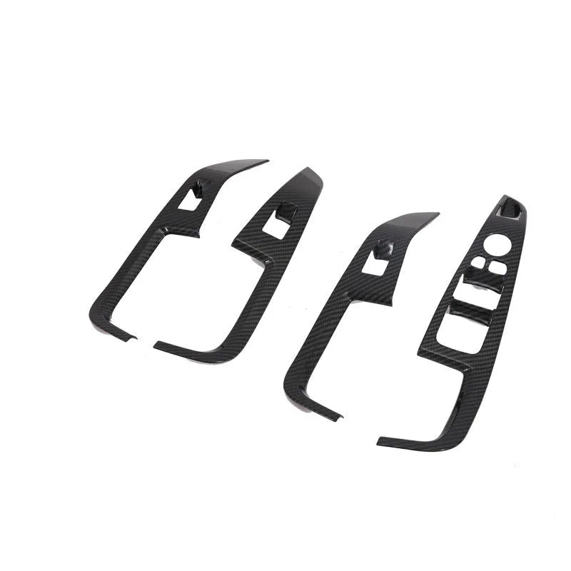 Matte black ABS plastic centre console trim panel for BMW X5 with cup holder and air vent controls.