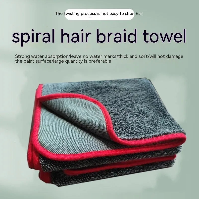 Grey automobile cleaning cloth with black edging showing spiral hair texture and hemmed edges