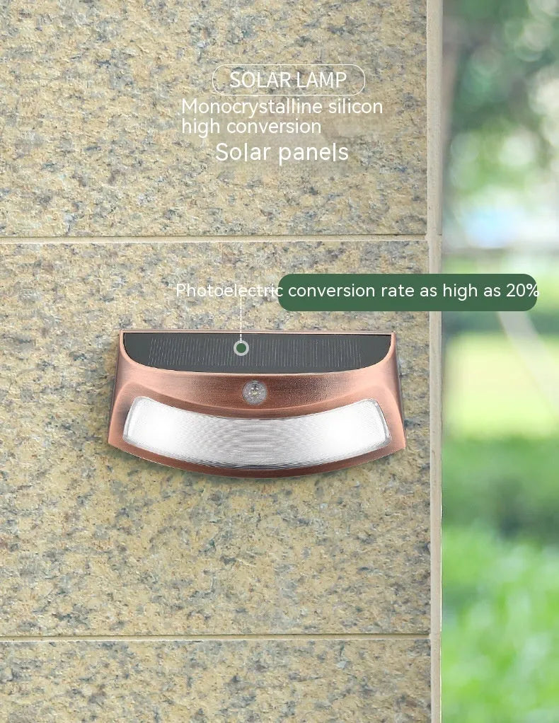 Solar-powered decorative wall lamp with smiling face design for outdoor garden lighting