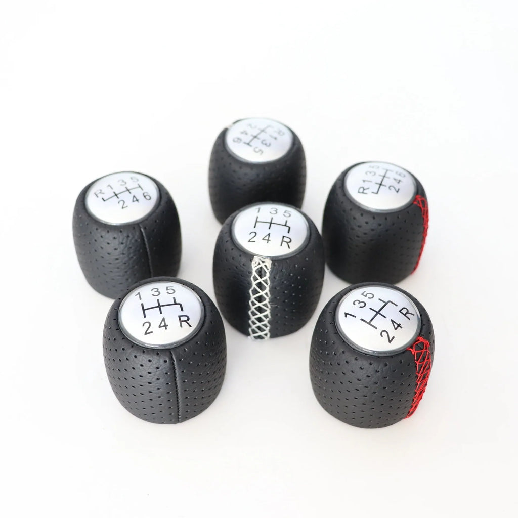 Sewn wrapped perforated leather handball gear for Alpha vehicles in Black, Red, and White Line options.