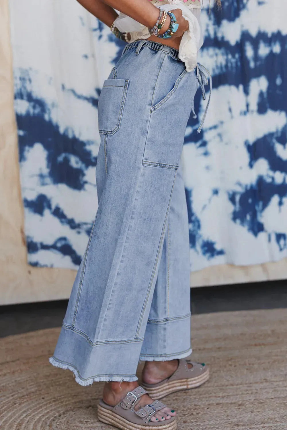 Beau blue wide-leg denim trousers with drawstring waist and raw hem detailing