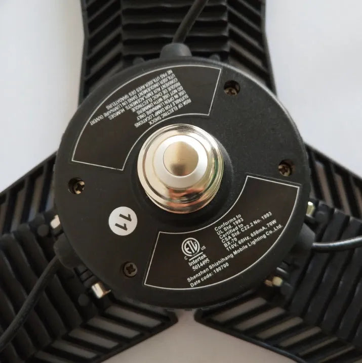 Foldable silver die-cast aluminium industrial LED lamp with a wide-angle lens for garage lighting.