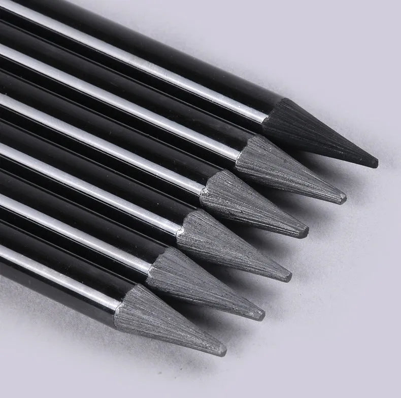 Set of nine art pencils on a card: six graphite pencils and three darker carbonized pencils in wooden casings.
