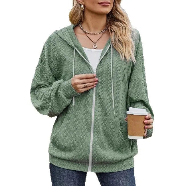 Green loose-fit women's hooded sweater coat with a front zipper and long sleeves on a hanger.