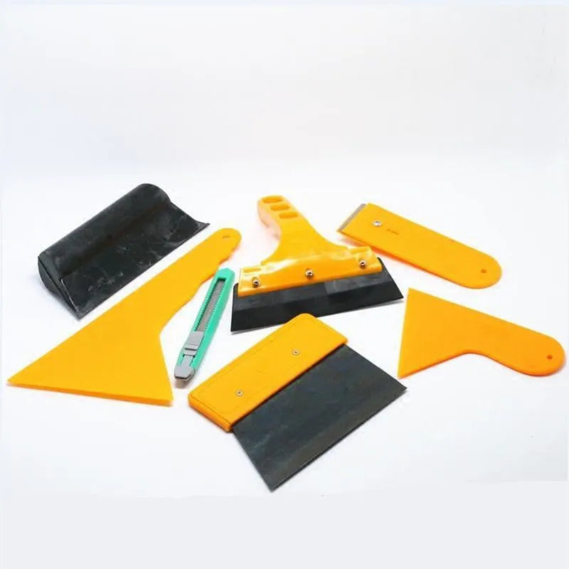 Seven-piece car film tool set with scrapers, knives, and a pressing block for window tinting and screen protector application.