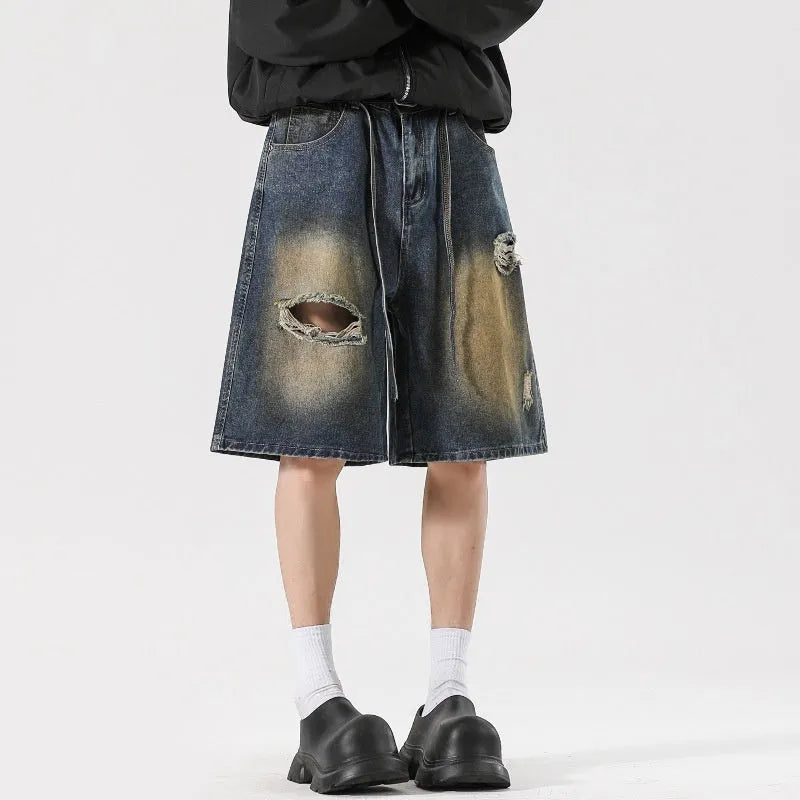 Retro blue loose fit ripped jeans with distressed detailing and street style design