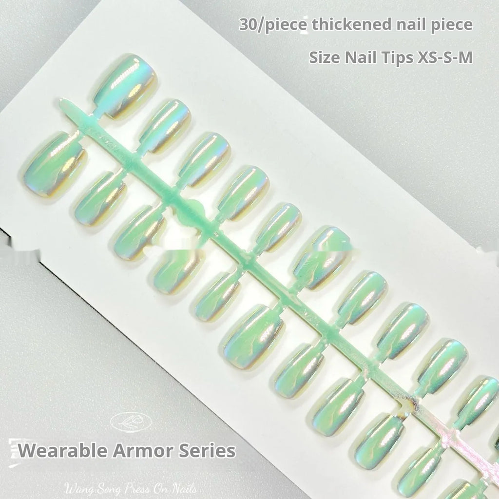 Set of electroplated Cat's Eye false nails with Aurora shine in short ladder sizes on a plain background.