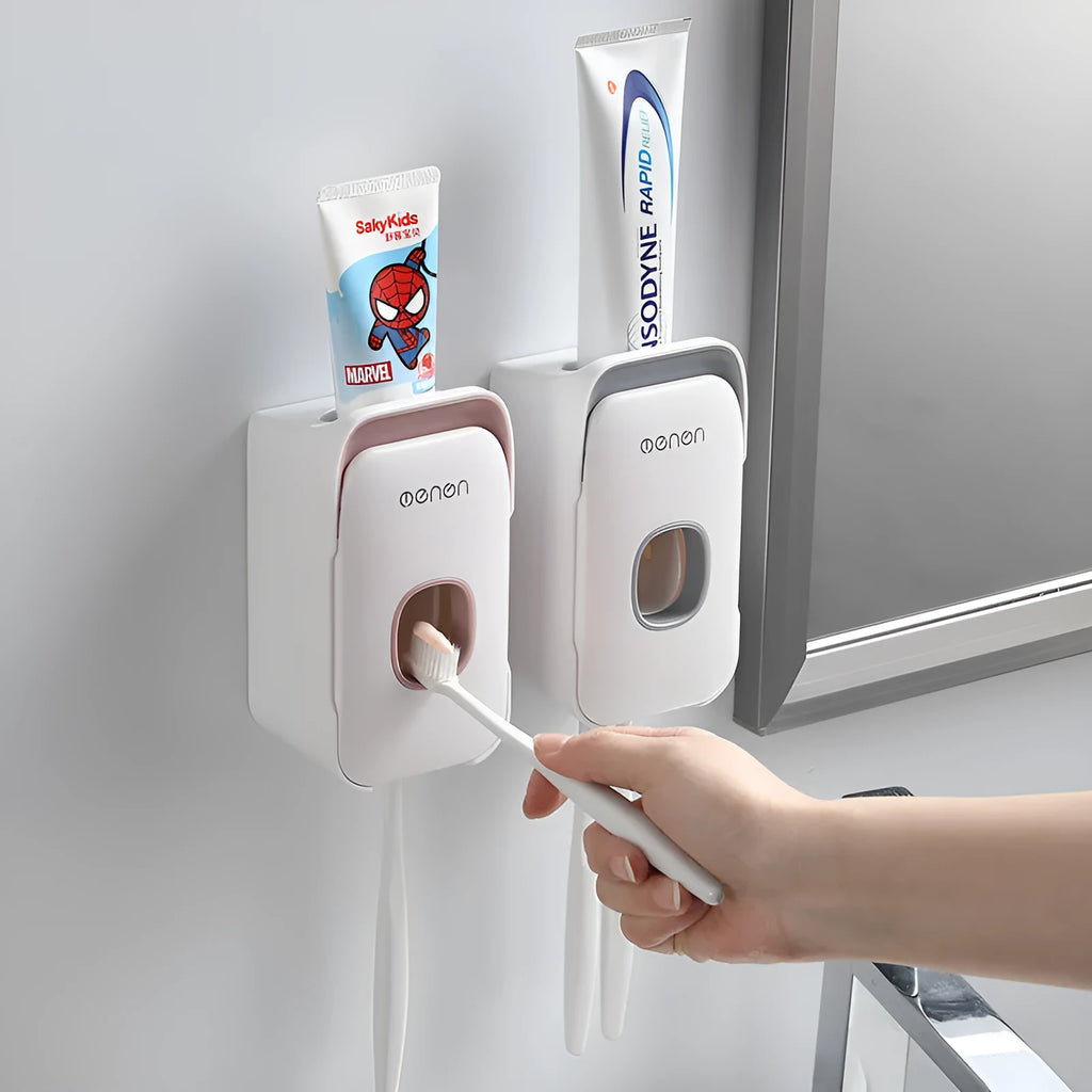 Automatic toothpaste dispenser in ABS plastic with suction cup wall mount in blue, grey, and pink colour options