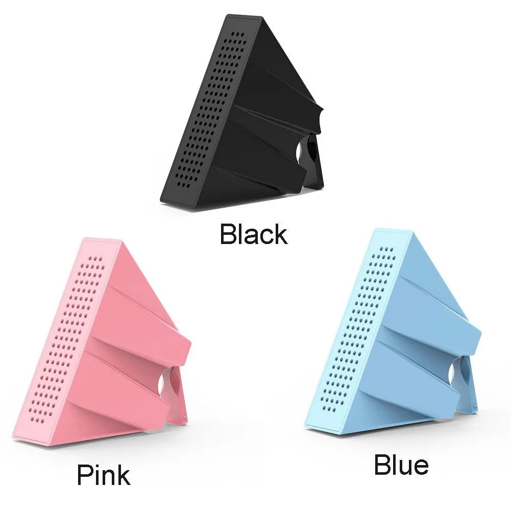 Mini black plastic phone amplifier bracket holding an Apple iPhone on a desktop
