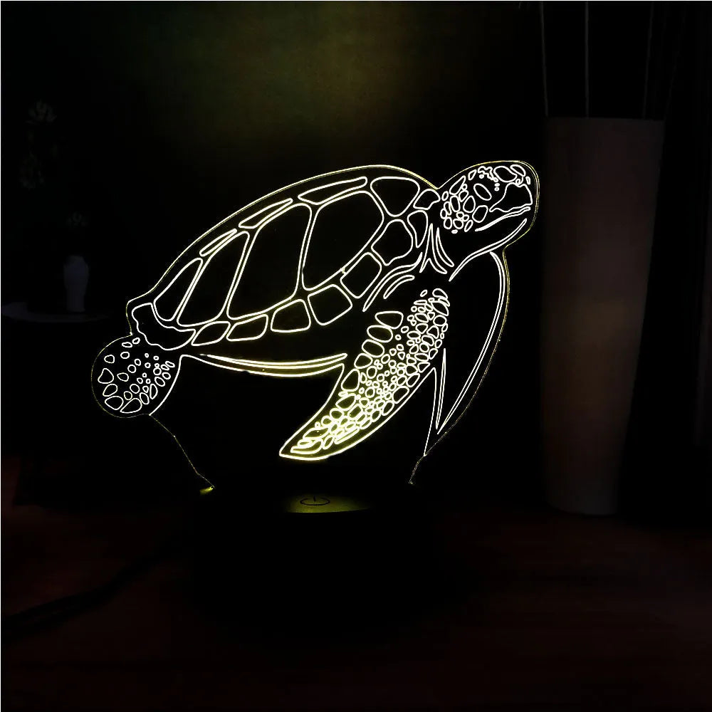 3D acrylic turtle-shaped night light glowing with multi-coloured LED light.