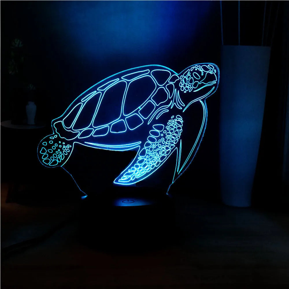 3D acrylic turtle-shaped night light glowing with multi-coloured LED light.