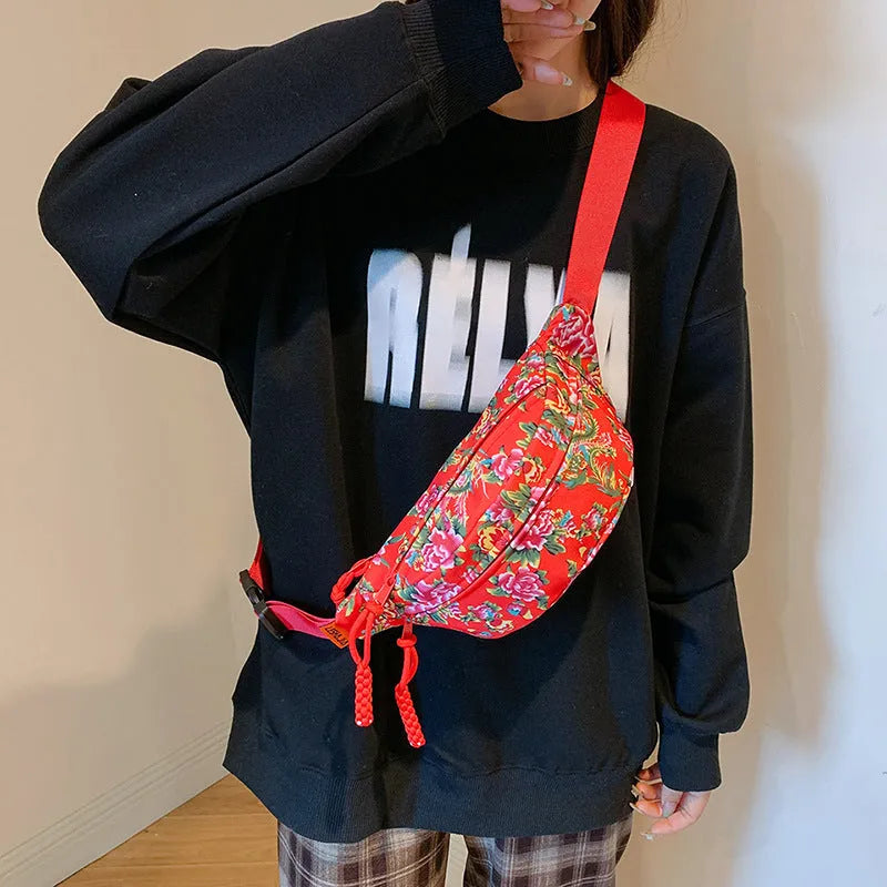 Women's Western-style floral waist bag in nylon with adjustable strap showing contrast stitching