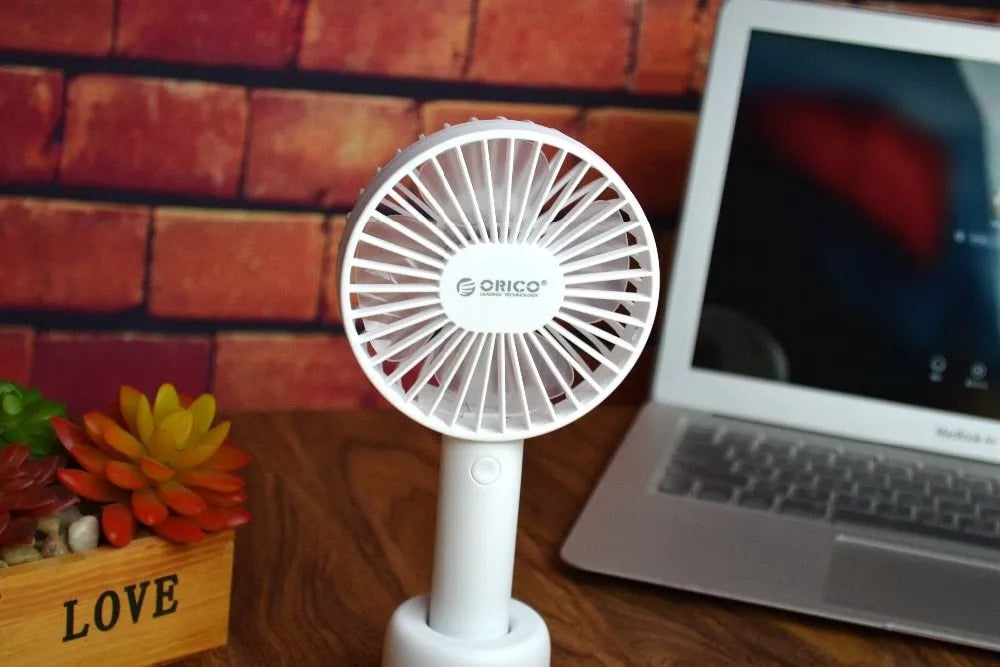 White ORICO FH1 portable USB rechargeable fan with three-speed control on desktop