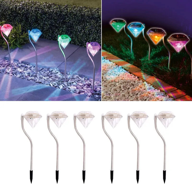 White solar-powered diamond-shaped garden spotlight with adjustable head on a stake for outdoor installation.