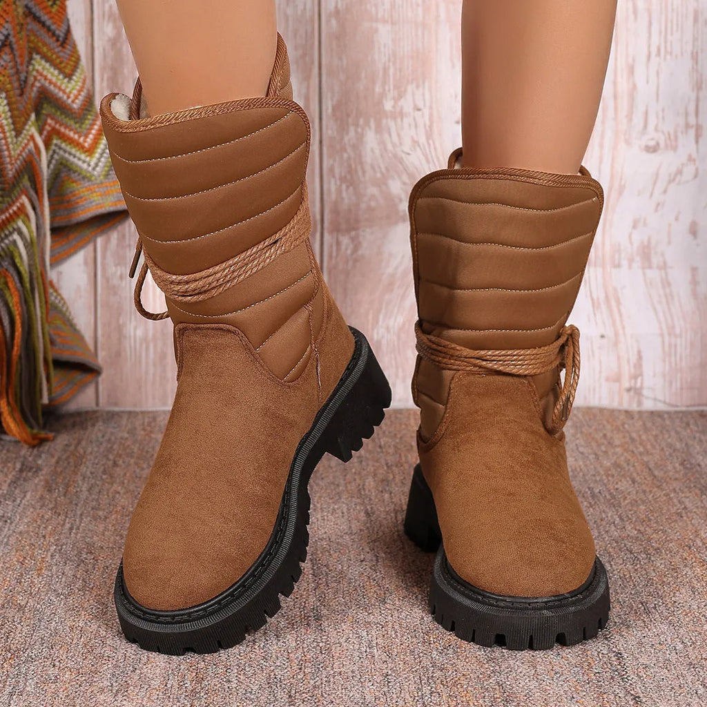 Women's black chunky heel snow boots with lace-up front and fleece lining on a white background.
