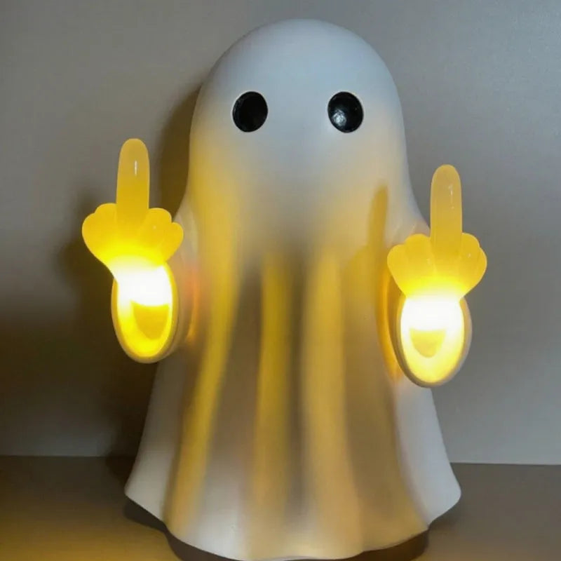 Small white ghost-shaped plastic night lamp for Halloween decoration on a table.