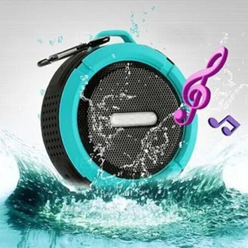 Compact portable Bluetooth stereo speaker with mountaineering buckle, shown in multiple colour options.