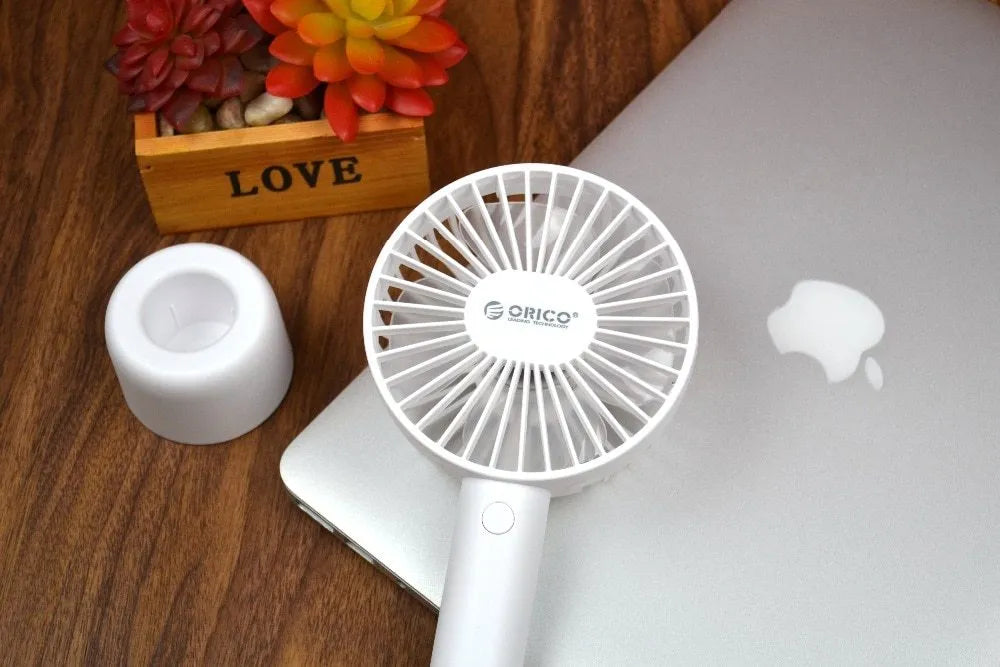 White ORICO FH1 portable USB rechargeable fan with three-speed control on desktop