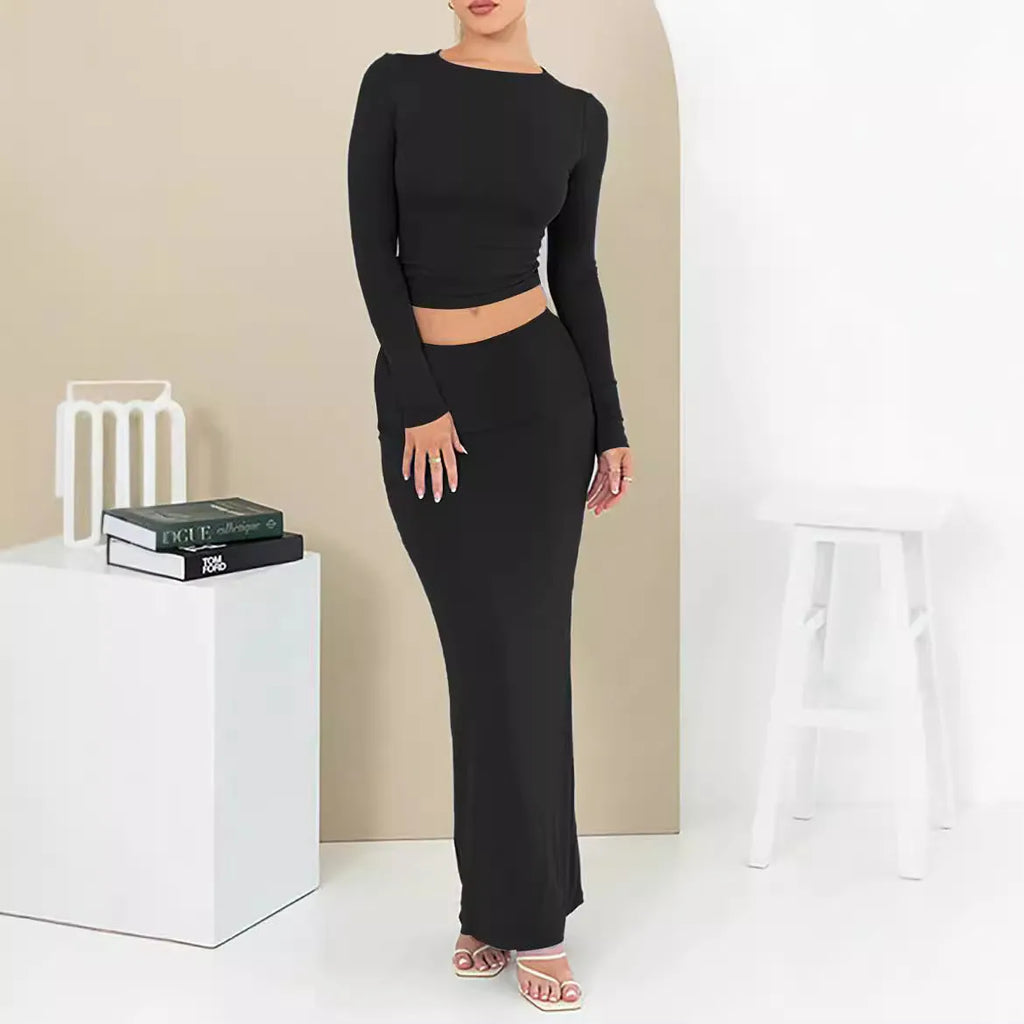Women's slim fit polyester two-piece suit set with three-quarter sleeves and long skirt in black.
