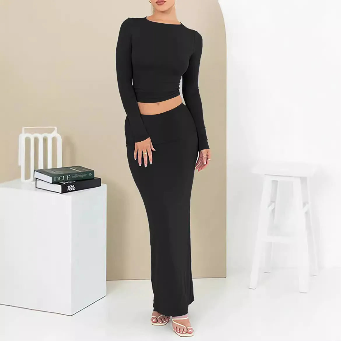 Women's slim fit polyester two-piece suit set with three-quarter sleeves and long skirt in black.