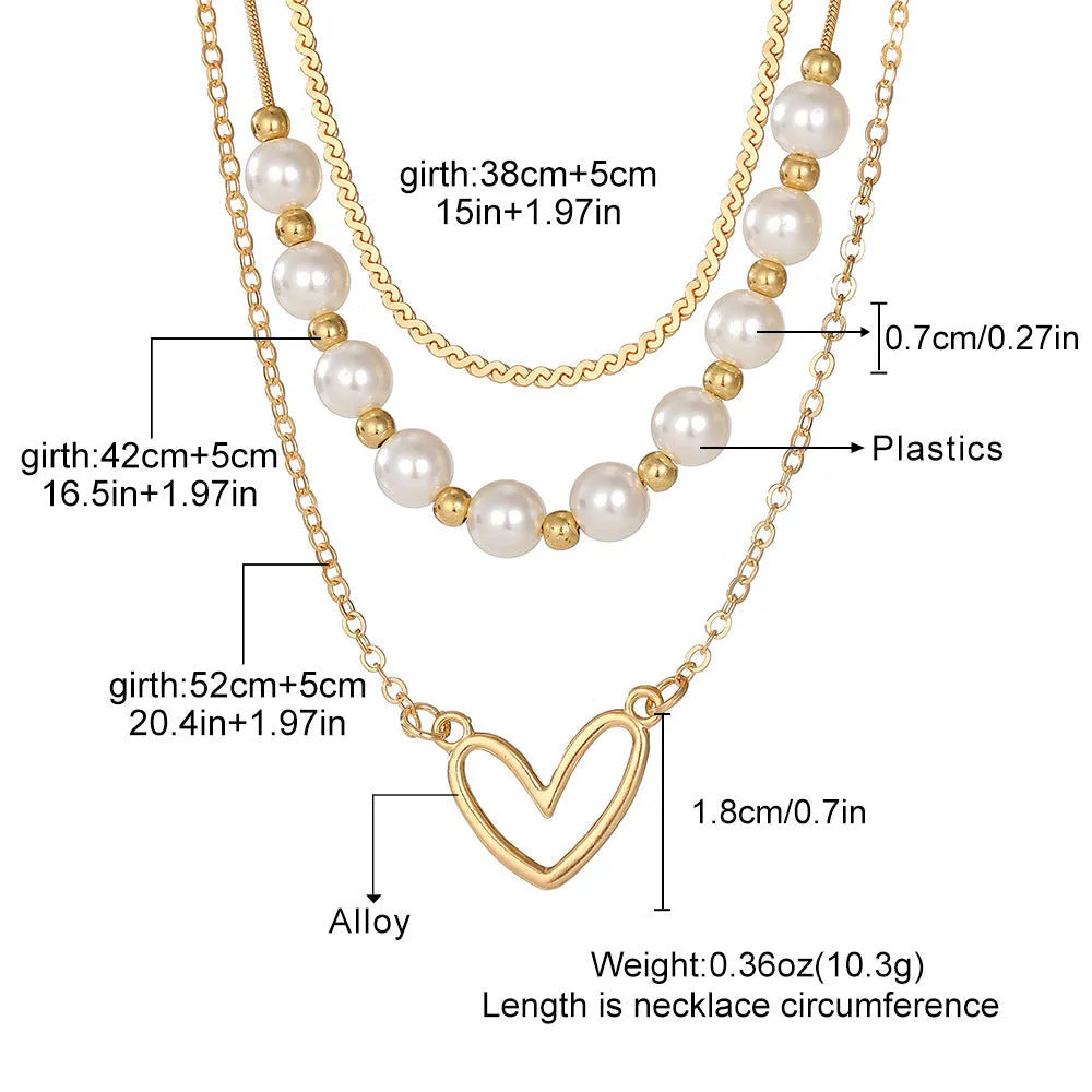 Vintage gold necklace with heart pendant and pearl details on chain