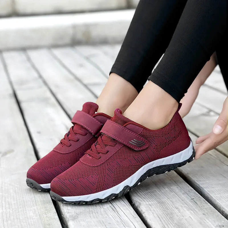 Women's grey purple breathable mesh shoes with a velcro strap and wedge heel on a composite sole.