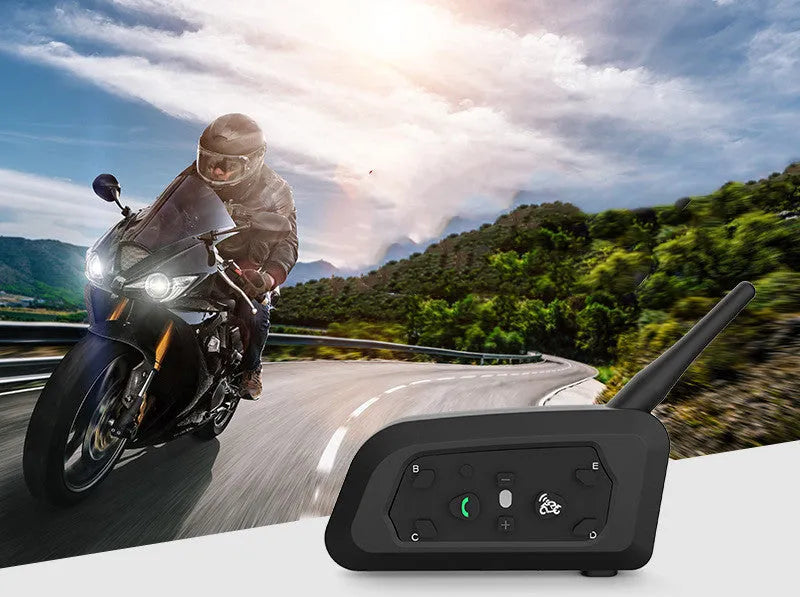 V6 Pro motorcycle Bluetooth intercom unit with mounting clip and charging cable on a motorcycle handlebar.