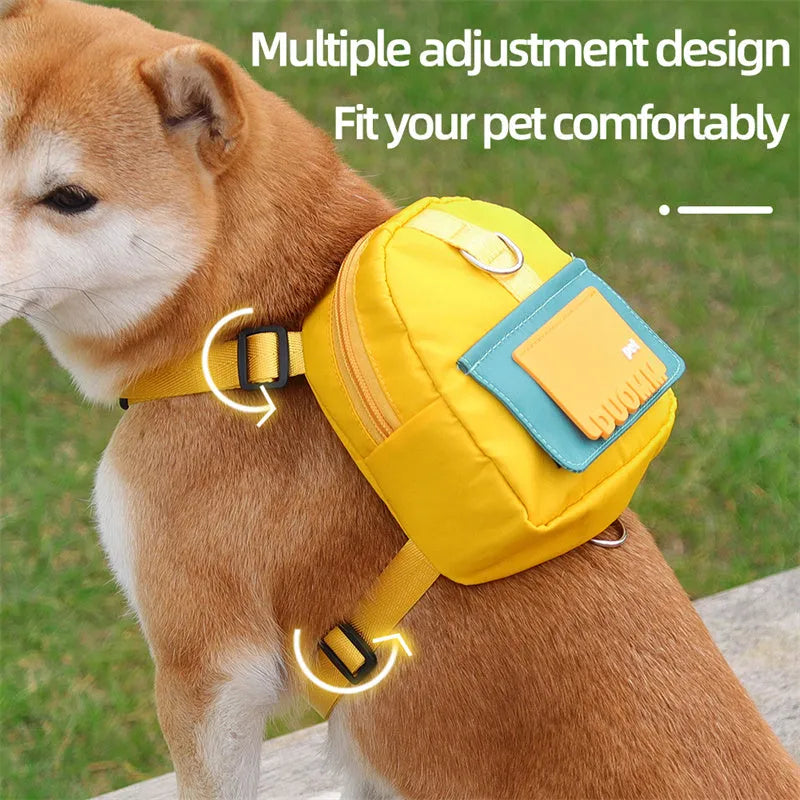 Blue adjustable dog backpack harness with storage pockets and a built-in tow rope laid flat.