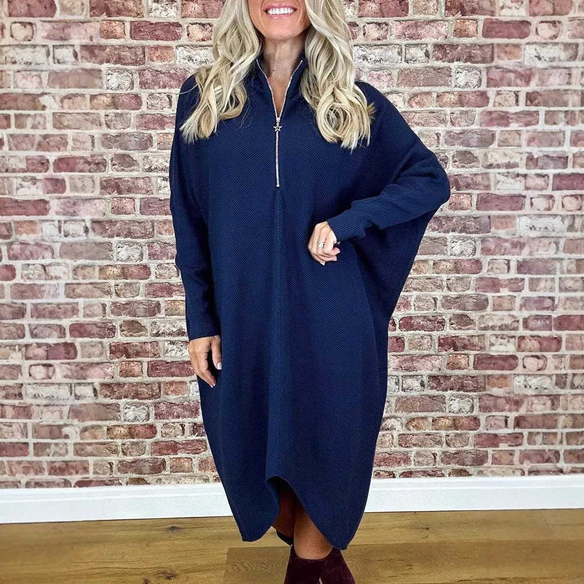 Women's solid colour knitted loose dress with zip and raglan sleeves, shown in dark green.
