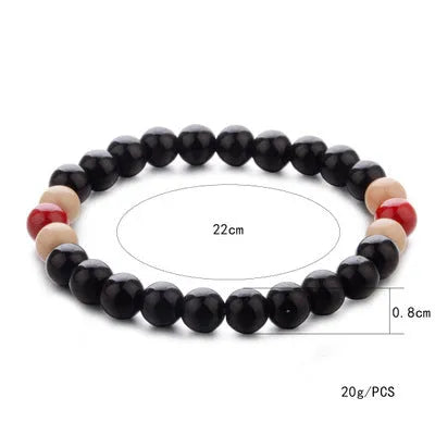 A natural stone bead bracelet with lava stone beads on a wrist, showing its ethnic style and approximately 18cm length.