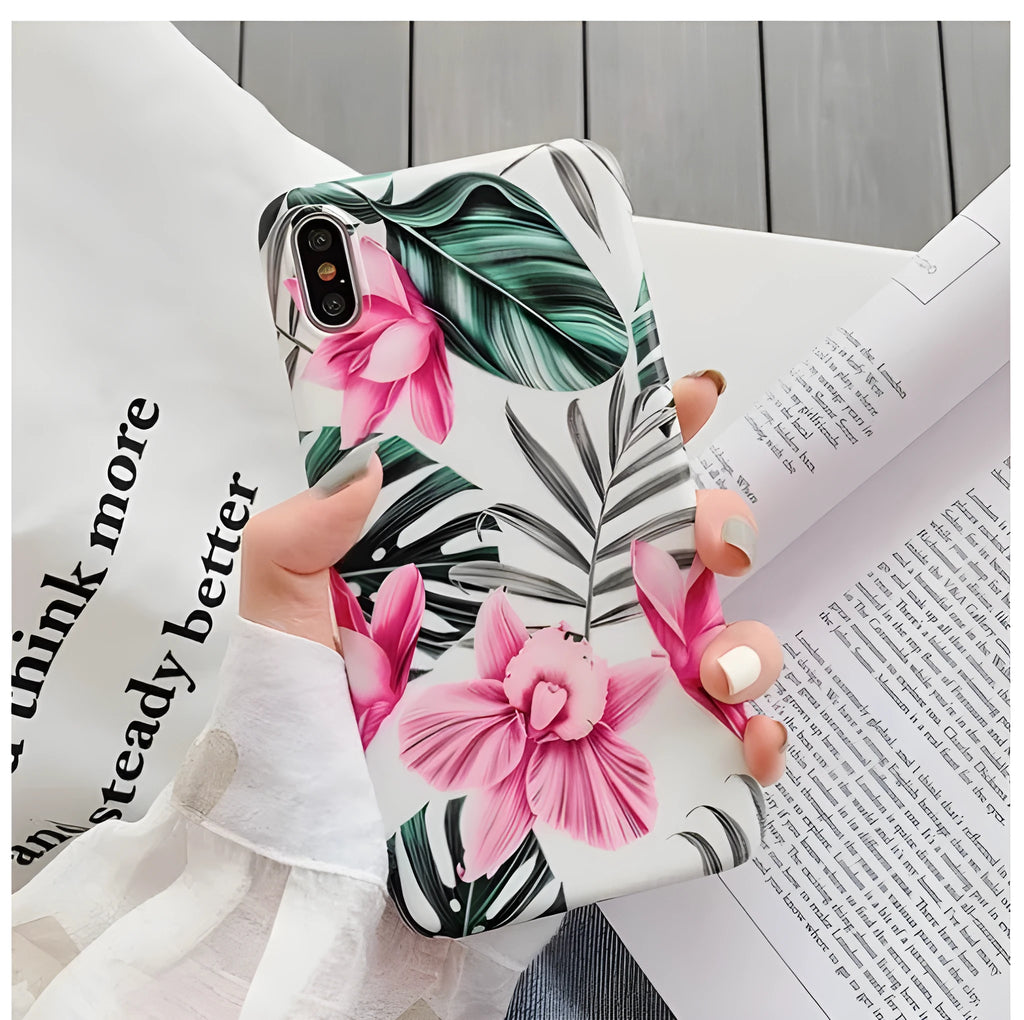Pink floral patterned TPU back cover case for iPhone on a table.
