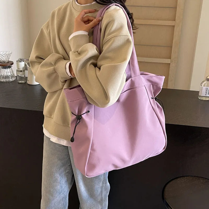Oxford cloth folding shoulder tote bag in a choice of five colours including black, brown, and purple.