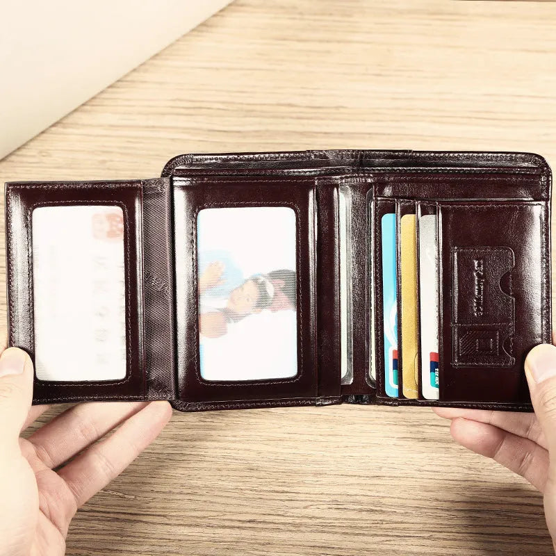 Men's leather wallet open to show internal card slots, cash section, coin pocket, and document holder.