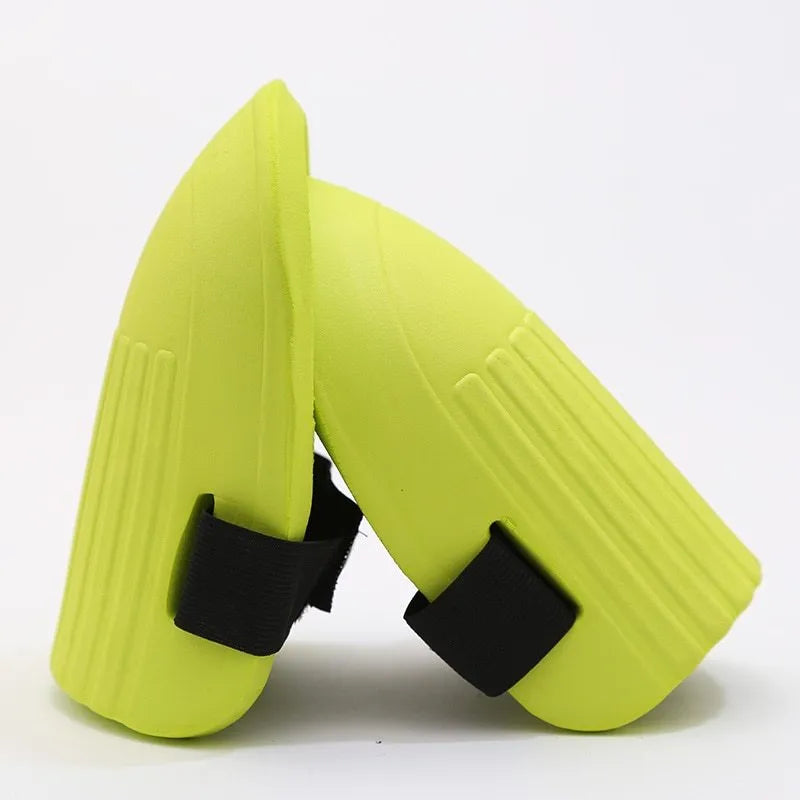 A pair of black EVA foam knee pads for gardening, showing their rectangular shape and soft texture.
