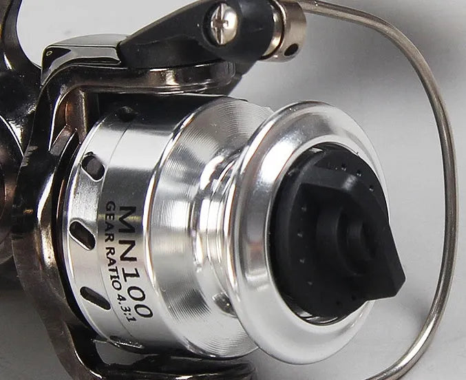 Mini 100 all metal black fishing reel with folding wooden rocker arm on white background